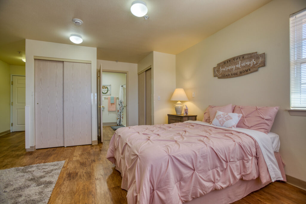 Interior image of a resident's studio with full size bathroom, mini kitchenette, and spacious living area.