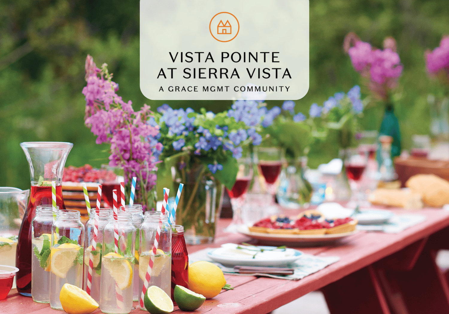 Table in garden with flowers and drinks on it