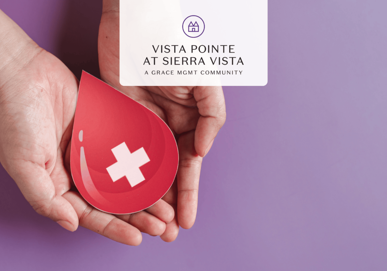 Hands cupping a red blood-drop cutout with a white cross, symbolizing blood donation, on a purple backdrop with a white card text above.